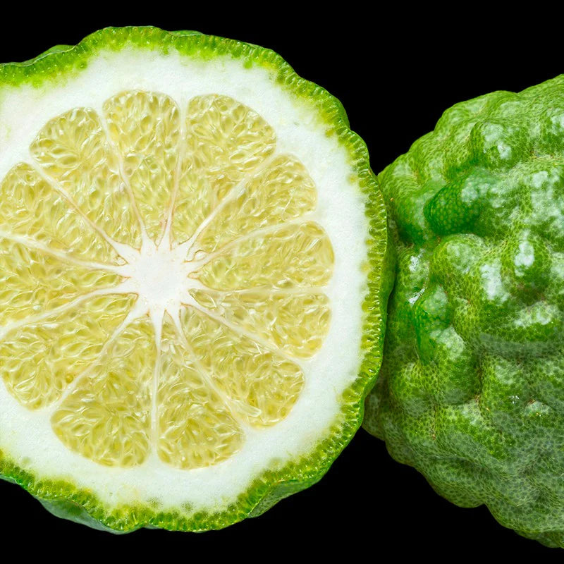 a lime is cut in half on a black background