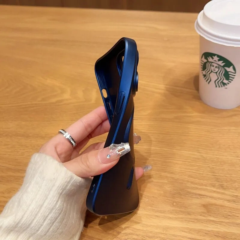 a woman's hand holding a cell phone in front of a cup of coffee